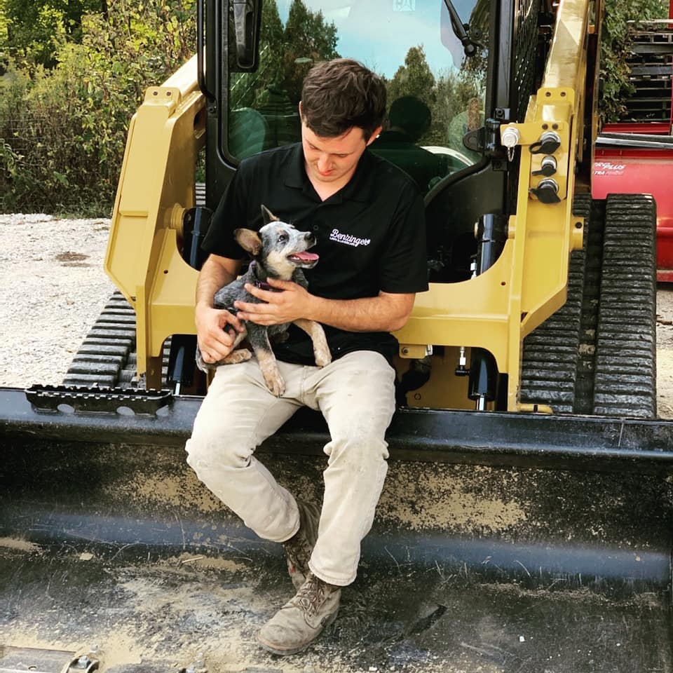 Benzinger Pools owner, Grant, holding his dog, Corky